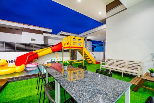 a playground with a slide in a house at Cocomelon Poolvilla1 in Hua Hin