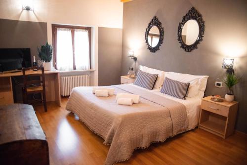 a bedroom with a large bed with two towels on it at Pietra di Verona Residenza in Verona