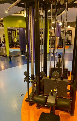 a gym with a bunch of equipment in it at the971stay in Dubai