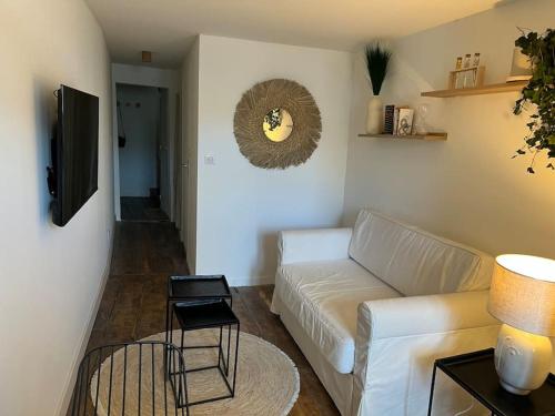 a living room with a white couch and a table at Superbe duplex hypercentre dans une rue piétonne in Limoges