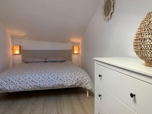 a bedroom with a bed and a white dresser at Superbe duplex hypercentre dans une rue piétonne in Limoges