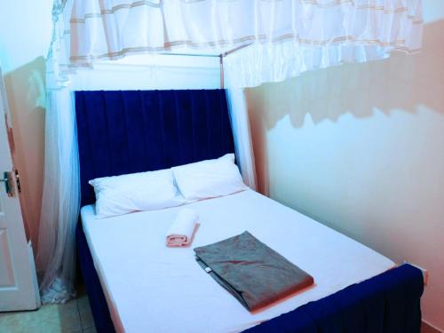 a bed with a book sitting on top of it at Bamburi 2 bedroom Luxury homes in Bamburi