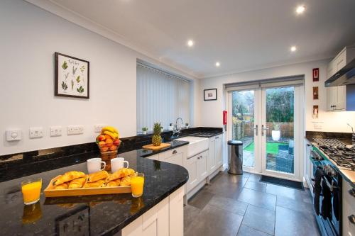 a kitchen with a counter top with oranges on it at Casa One Hundred - A Beautiful 4 Bed House on the Beach Front in Swansea