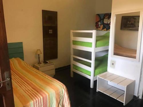 a bedroom with a bed and a dresser and a bunk bed at Amaaral in Rocha