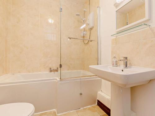 a bathroom with a sink and a toilet and a shower at 3 Bed in Falmouth CONSW in Constantine