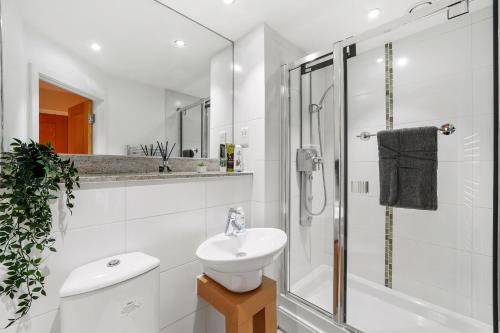 a white bathroom with a sink and a shower at LiveStay-Stunning 2 Bed 2 Bath Apartment in Maida Vale in London