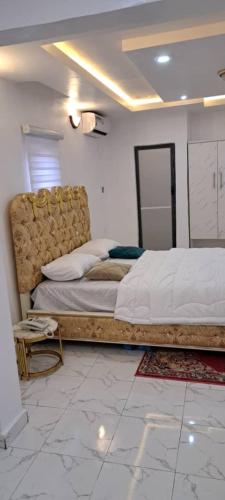 a bedroom with a large bed in a room at De Miami Park Suites & Bar in Owerri