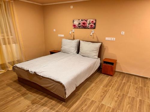 a bedroom with a bed with two pillows at Krisz Apartman in Gyula