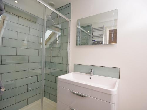 a white bathroom with a sink and a mirror at 1 Bed in Curry Rivel 41489 in Curry Rivel