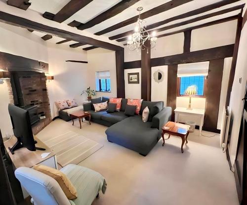 a living room with a couch and a tv at 12A College Hill by Sleep Shrewsbury in Shrewsbury
