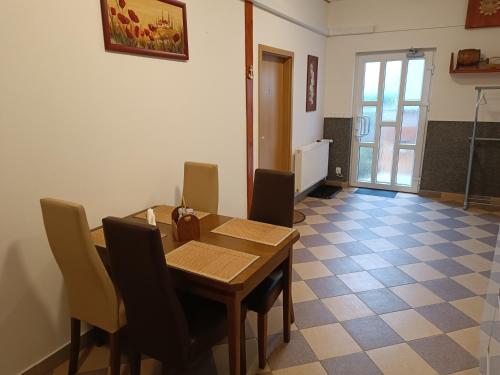 a dining room with a wooden table and chairs at U Bocmana s výhledem na zámek a Labe in Děčín