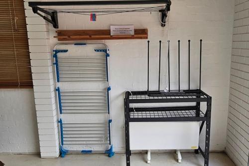 a room with two metal bunk beds and a shelf at Perfect Country Home in Tawonga