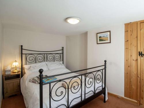 a bedroom with a bed and a wooden door at 2 Bed in Little Walsingham KT093 in Little Walsingham