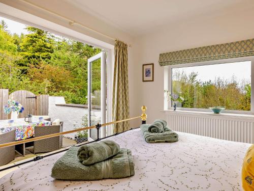 a bedroom with a bed and a large window at 2 Bed in Bethesda 66276 in Llanddeiniolen