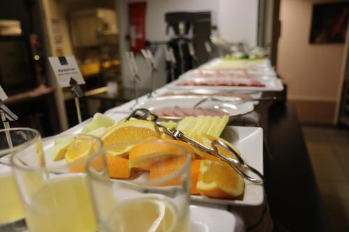 a row of plates of food with fruit on them at Hotell Vilja in Umeå