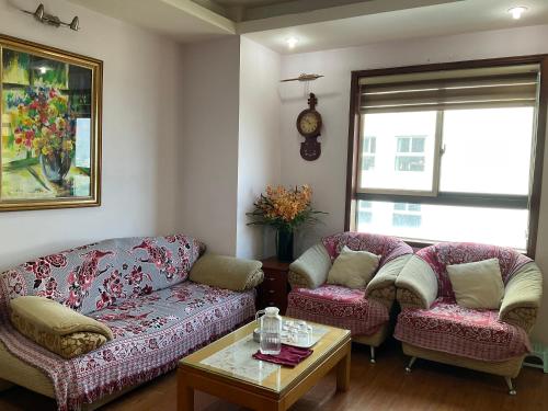 a living room with a couch and two chairs at Westlake Tay Ho Hotel 696 Lạc Long Quân in Hanoi