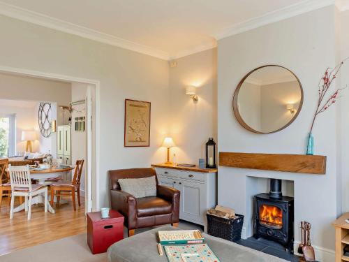 a living room with a fireplace and a chair and a table at 2 Bed in Harrogate 74981 in Harrogate
