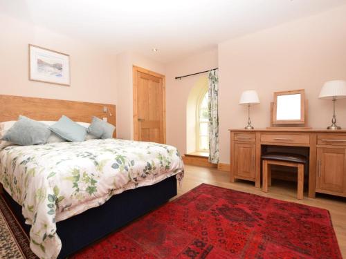 a bedroom with a bed and a desk and a mirror at 2 Bed in St Andrews 75868 in Ladybank