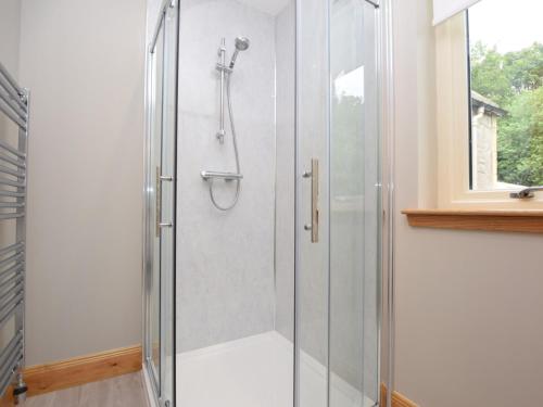 a shower with a glass door in a bathroom at 2 Bed in St Andrews 75868 in Ladybank