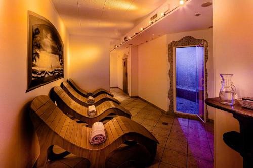 a room with a wooden bed in the middle of a room at Hotel Nigritella in Selva di Cadore