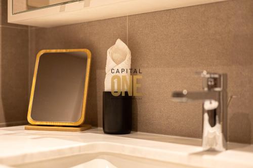 a bathroom with a sink and a mirror next to a sink at Luxurious 3BR Apartment Amazing view of Burj Khalifa in Dubai