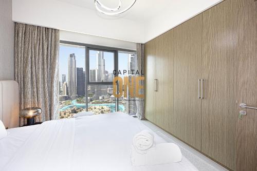 a hotel room with a large bed and a window at Luxurious 3BR Apartment Amazing view of Burj Khalifa in Dubai