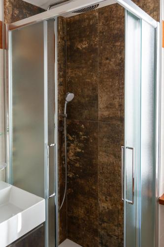 a shower with a glass door in a bathroom at Agriturismo Il Giardino Degli Ulivi in Lazise