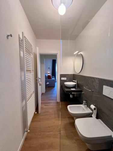 a bathroom with two toilets and a sink at CASA VACANZE LA BRENTA in Chiavenna