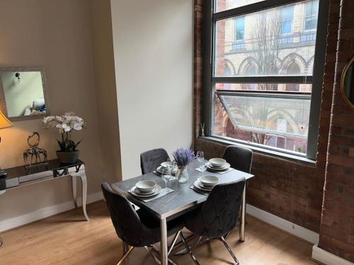 a dining room with a table and chairs and a window at Cornwallis 1 bedroomed 2 beds- sleeps 5- FREE Parking in Liverpool