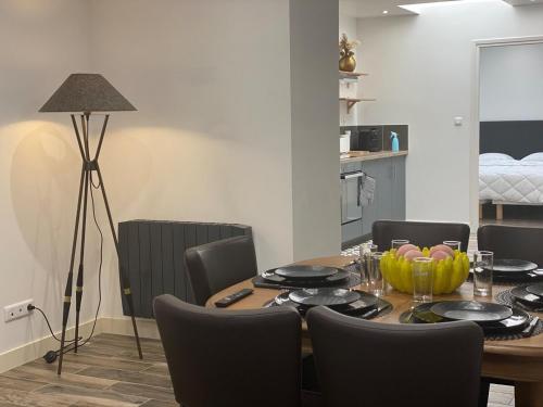 une salle à manger avec une table, des chaises et une lampe dans l'établissement Bienvenue au Ptit T'Anaïs,, à Boulogne-sur-Mer