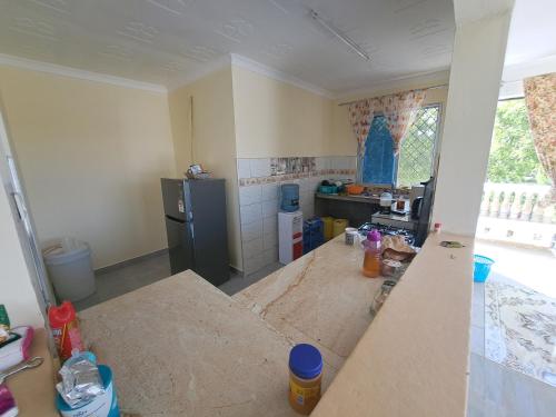 a kitchen being remodeled with a counter in the middle at Diamond Sands Villa in Ukunda