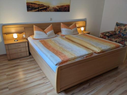 a bedroom with a large bed with two night stands at Appartement Karolina in Bad Soden-Salmünster