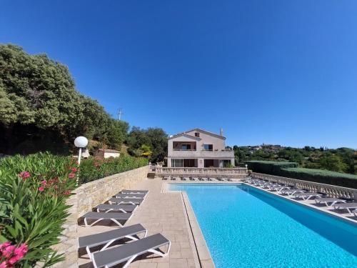 a swimming pool with lounge chairs and a house at Village de gîtes La Fontinelle in Bessas