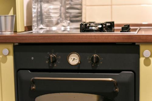 a black oven with a stove top on top of it at La Maison in Niš