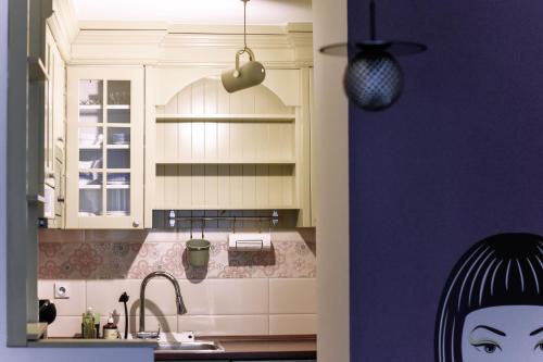a kitchen with a sink and a counter top at La Maison in Niš