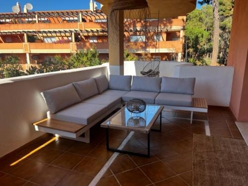 a couch and a table on a patio at Center beach 2 beds Appartement Elviria in Marbella