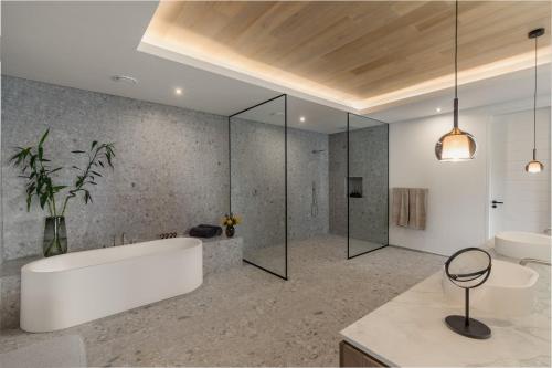a bathroom with a tub and a shower and a sink at Clouds Estate in Stellenbosch