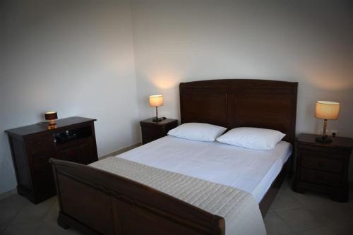 a bedroom with a large bed with two night stands at Icaria Great Filling House in Évdhilos