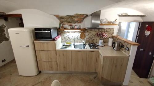 a small kitchen with a sink and a refrigerator at Dal Pescatore in Arenzano