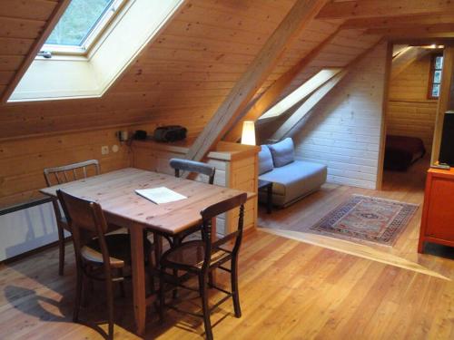 a room with a table and chairs in a attic at Gillausklause - eine Insel im Wald - Waldviertel 
