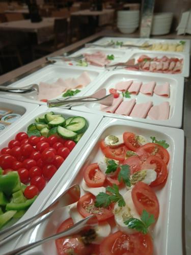 a row of trays filled with vegetables and meats at JUFA Hotel Graz Süd - Self Check-in in Graz