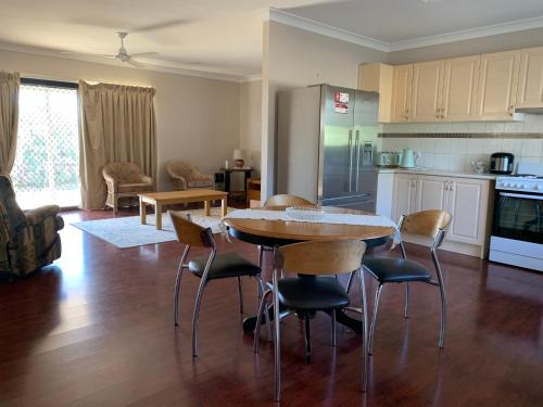 a kitchen and living room with a table and chairs at Almaden Country Rooms in Almaden