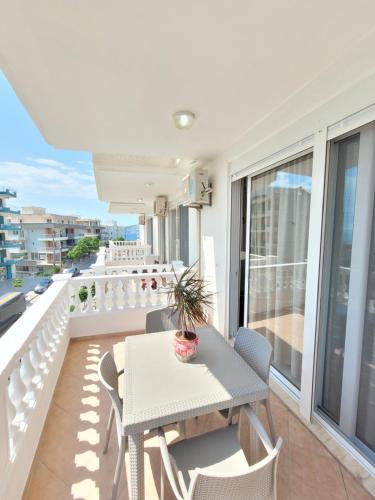 a balcony with a table and chairs on a balcony at Parid Appartments in Sarandë