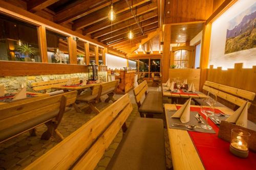 un restaurante con bancos de madera y mesas en una habitación en Berggasthof Lahnerhof, en Liesing