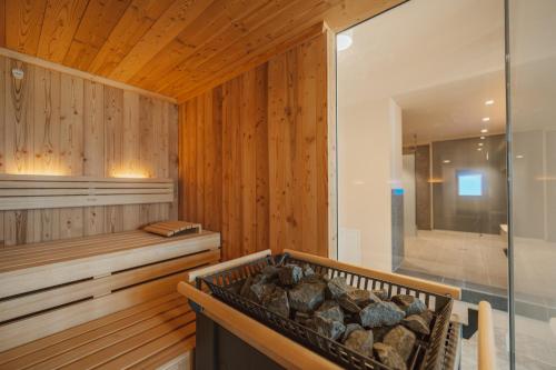 a room with a sauna with a wooden wall at Hotel Amalia - Boutique Hotel in Landshut