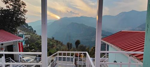 a view of the mountains from a balcony of a building at Belle Vue Chopta in Barmoāri