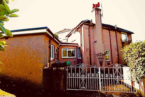 a house with a fence in front of it at Luxurious 2 Bedroom Private Detached Cottage in Llanddulas