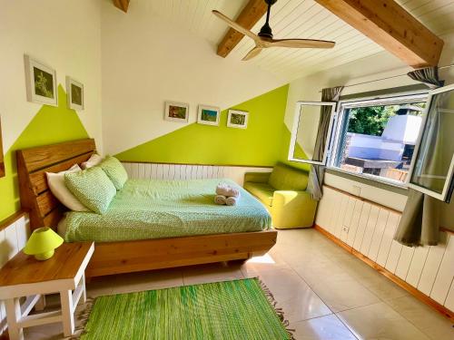 a bedroom with a bed and a table and a window at Sea Roots "Garden Zone " in Mosteiros