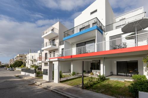 an apartment building with balconies on a street at Pagani Green - Luxury Maisonette I2 in Kalamata