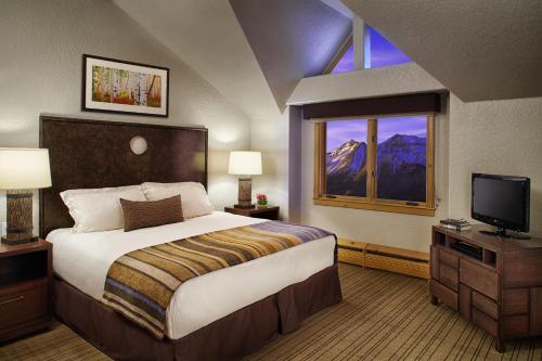 a hotel room with a bed and a television at Fairmont Heritage Place, Franz Klammer Lodge in Telluride